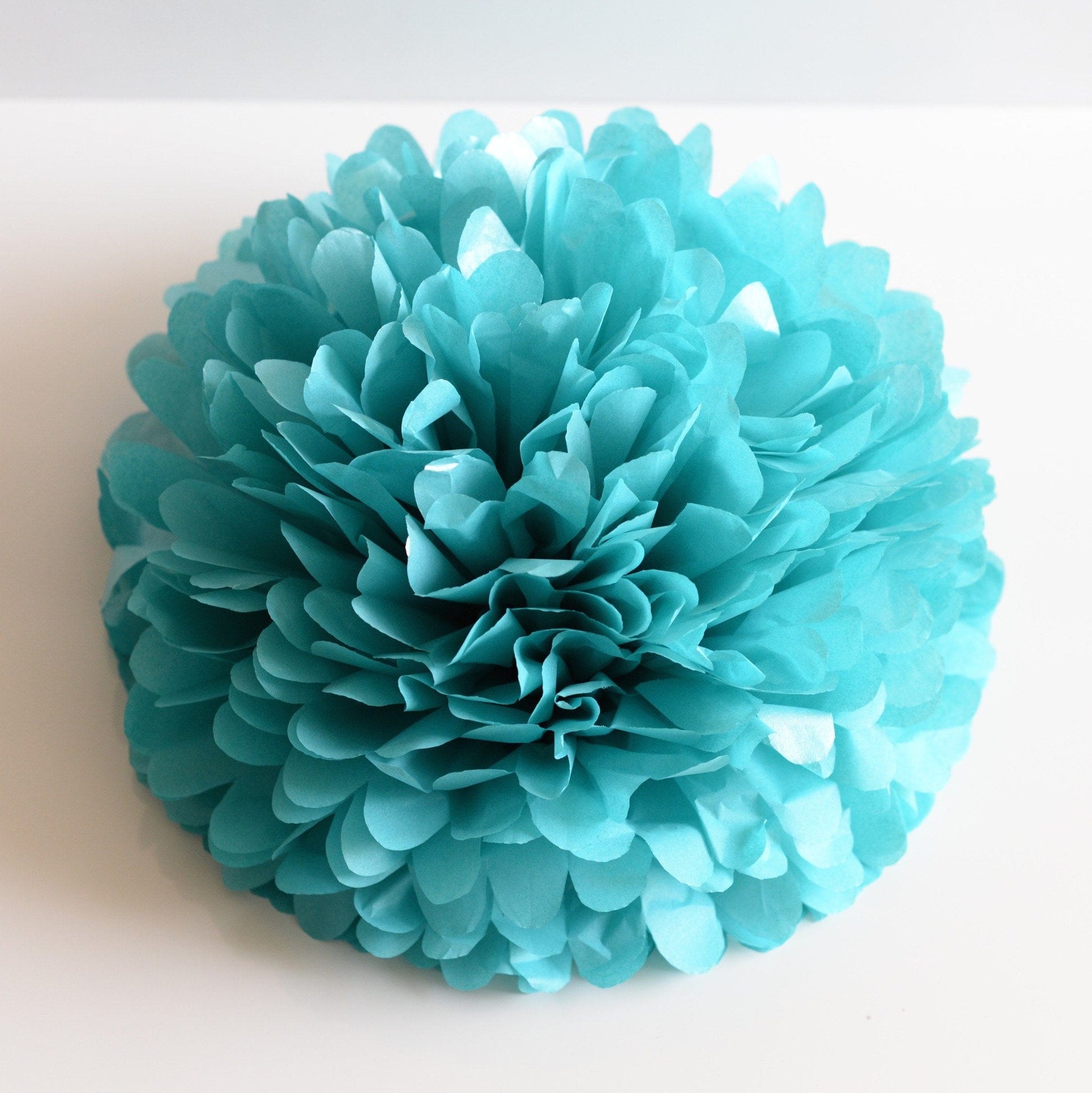 Shimmery turquoise paper pom poms - Decopompoms